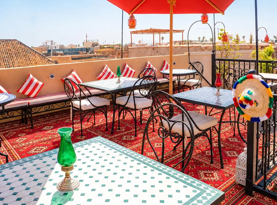 The terrace with its tiled table and red cushions