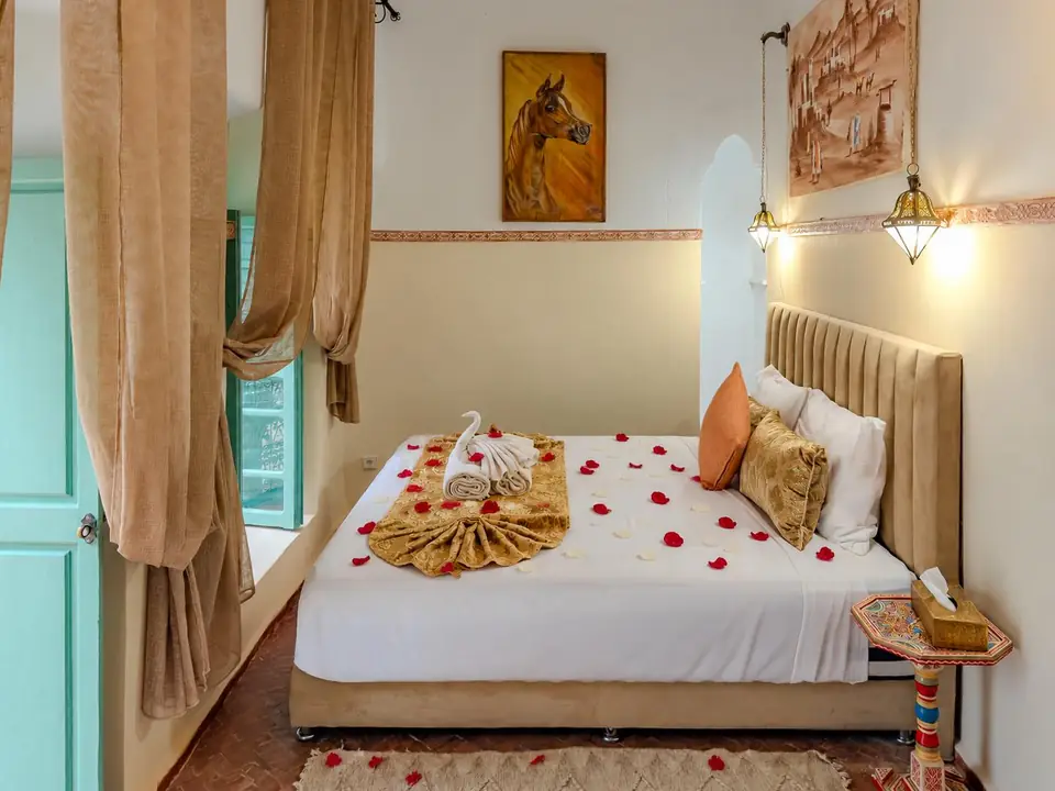 Safran room with saffron drapes and a velvet headboard