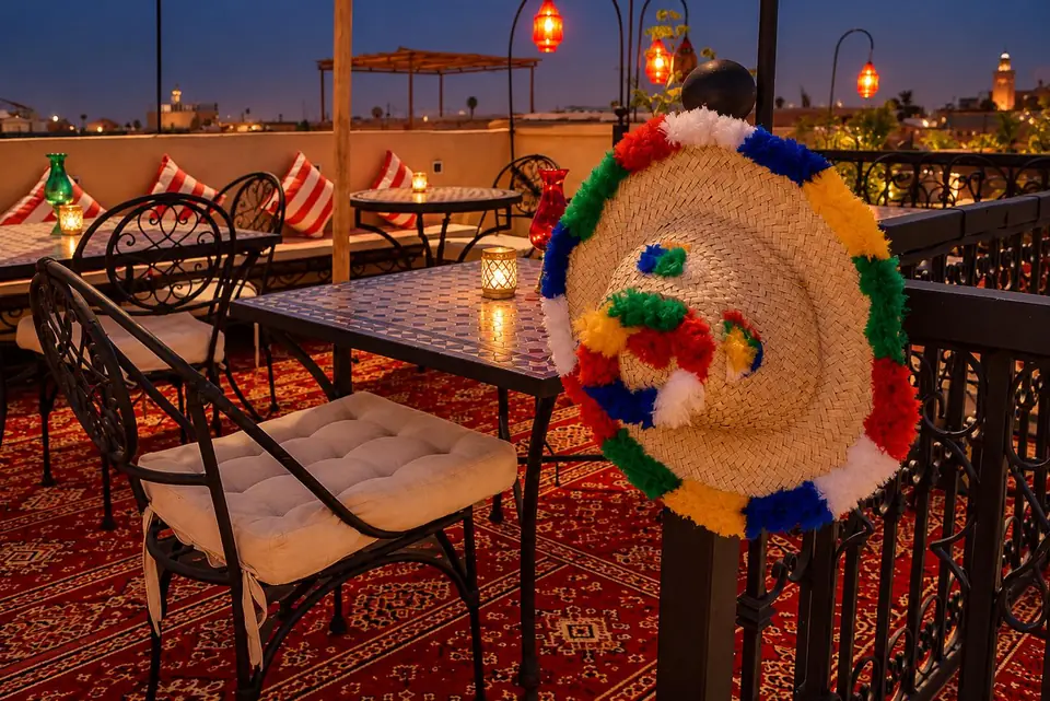 Rooftop chairs and a woven hat at dusk