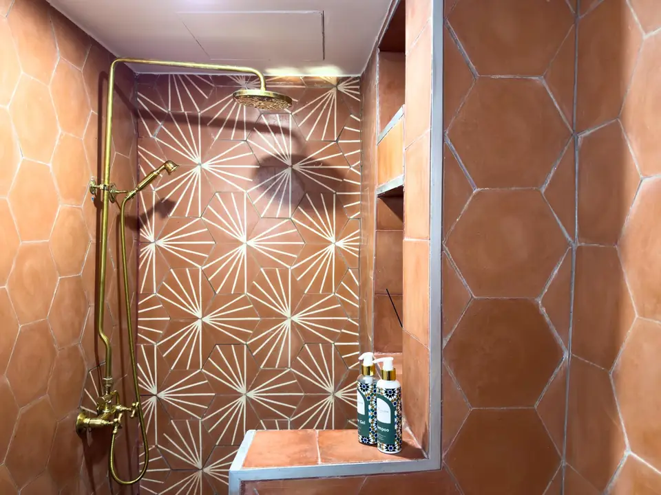 Terracotta star tiles and a brass shower
